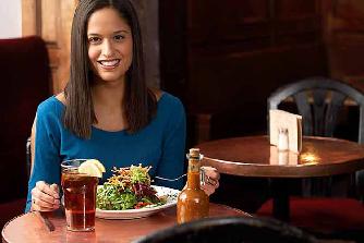 Woman eating Mediterranean salad